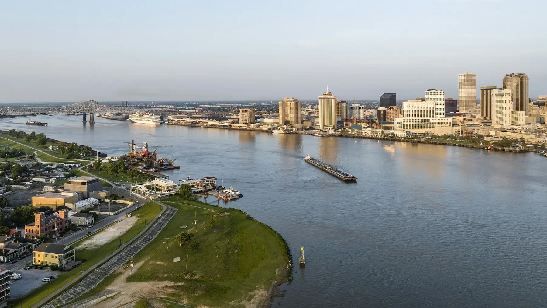 Aerial view of a bend in the Mississippi River with the New Orleans skyline in the distance